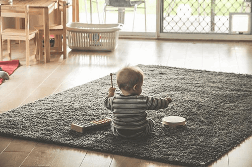 A baby playing with musical instruments.