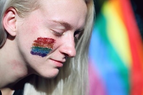 a person with rainbow face paint